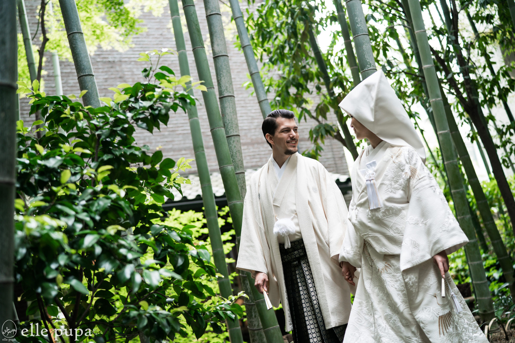 京都・豊国神社での結婚式（神前式）。竹林を歩きながら、ウェディングフォトを撮影する新郎新婦。
